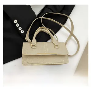 Macro-opname van beige geweven handtas met goudkleurige bar en handgreep boven