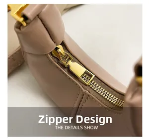 Macro detail of high-quality gold zipper hardware on a beige dumpling handbag