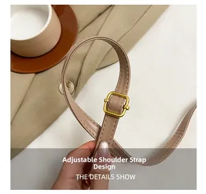 Close-up of light brown adjustable faux leather shoulder strap with gold metal buckle