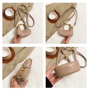 Detail view showing crescent shape, fine PU leather texture and gold hardware of the beige bag