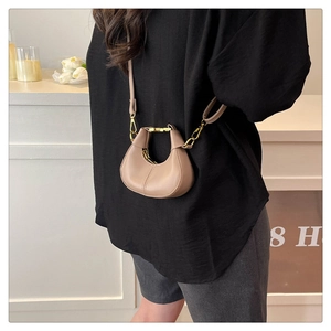 Detail of light khaki mini half-moon crossbody bag with smooth leather and gold hardware