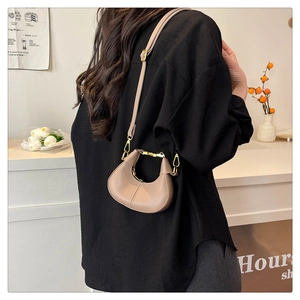Side view of a khaki crescent leather crossbody bag with adjustable strap and gold hardware