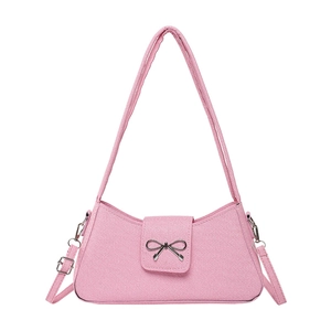 Pink baguette shoulder bag with metallic bow detail and stylish denim texture