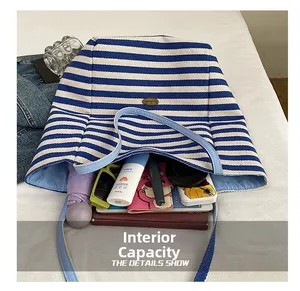 Spacious interior of blue and white striped canvas tote bag showing daily essentials