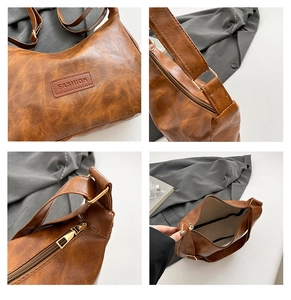 Macro detail of retro brown tote bag showing textured leather and fashion logo