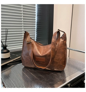 Detailed macro shot of vintage brown PU leather bag with Fashion label and metal buckle