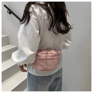 Detailed back view of pink plaid crossbody waist bag worn by a model in casual style