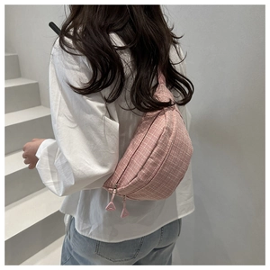 Close-up of pink checkered waist bag featuring double zippers and smooth canvas texture