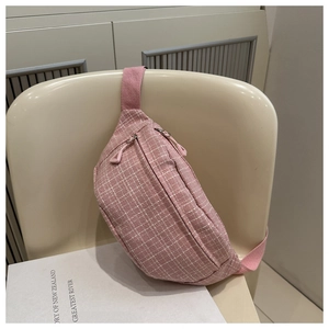 Detail of pink plaid waist bag with woven texture and double zipper closure details