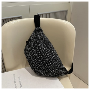 Detail of tweed waist bag with houndstooth pattern and matte triangle zipper pulls