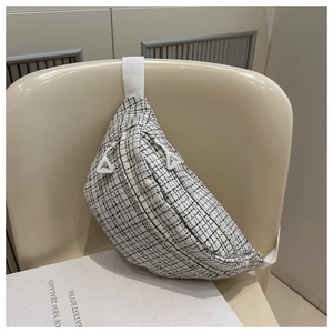 Detail of black and white checkered tweed fanny pack with white triangular zipper pullers