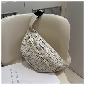 Detail of tweed checkered crossbody chest bag with double zippers and nylon strap