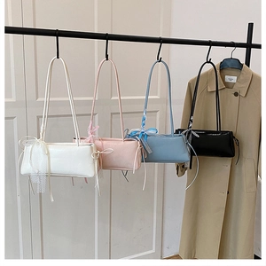 French minimalist underarm bags in multiple colors with delicate lace bow detail