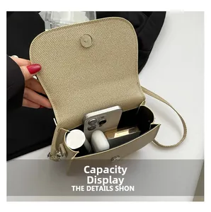 Macro view of beige woven saddle bag showing capacity for phone, lipstick and earbuds