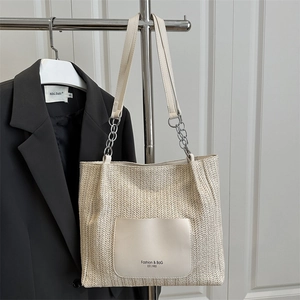 Minimalist woven straw tote bag in cream white with silver chain leather shoulder straps