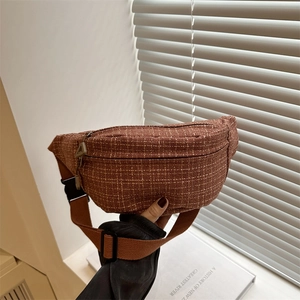 Brown plaid tweed crossbody fanny pack for women with adjustable strap shown in aesthetic setting