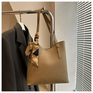 Detail of khaki tote bag with fashion print silk scarf and FASHION & BAGS lettering