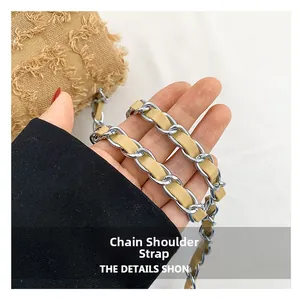 Close-up of woven chain shoulder strap with silver metal and beige leather details