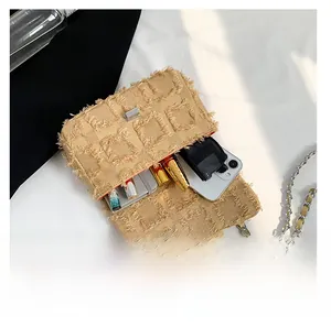 Internal view of khaki fringed crossbody bag showing capacity for phone and cosmetics