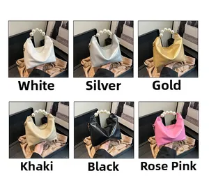 Detail shot of mini pillow bags with pearl handles in six colors including silver and gold