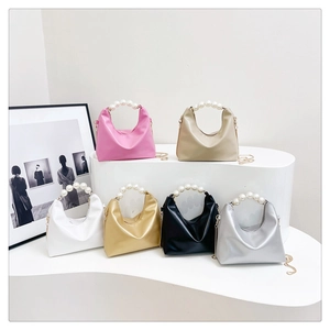 Collection of six mini dumpling bags with pearl handles and gold chains in assorted colors