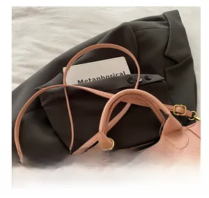 Detail der rosa Leder-Beuteltasche mit bronzenem Drehverschluss und rundem Handgriff