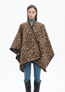 Close-up of thick leopard print shawl with black stitched edges and oversized silhouette