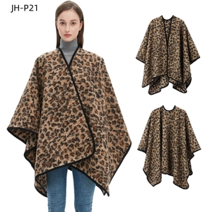 Close-up of thick knit leopard print shawl featuring classic brown and beige tones