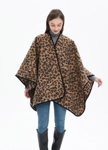 Detail of thick leopard print shawl with black stitched edges and open-front oversized design