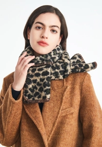 Close-up of thick leopard print scarf with soft loop yarn texture and finished edges