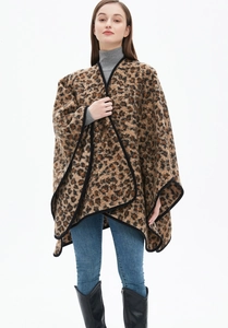 Detailed front view of a thick leopard print poncho shawl with black hemmed edges