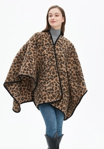 Detail of leopard print shawl with black stitched edges and thick cozy fabric texture