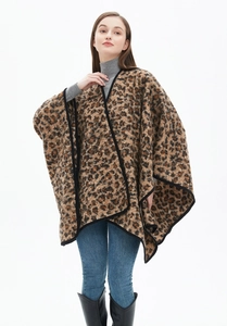 Detail of thick leopard print shawl featuring high-quality knit texture and black piping