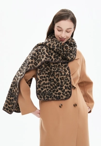 Close-up of thick leopard print scarf with whipstitch edges on a camel wool coat