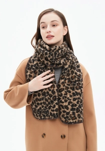 Close-up of leopard print scarf texture with premium fuzzy boucle yarn material