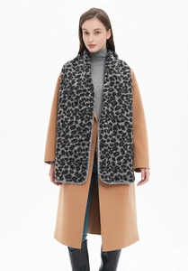 Detail of the leopard print thick scarf with professional overlock edge stitching on gray wool