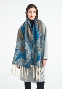 Detail of star pattern jacquard knit scarf with thick cream fringe and soft texture