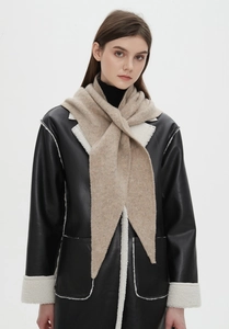 Detail of oatmeal knit scarf paired with a black faux shearling biker jacket