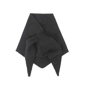 Detail of dark grey knitted wool shawl scarf with triangle wrap and knot texture