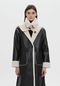 Detail of wool knit scarf collar paired with black matte leather and faux fur coat