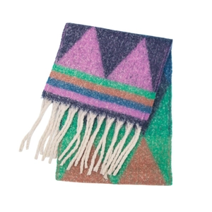 Detailed view of the jacquard knit texture and long white fringe on a fuzzy scarf