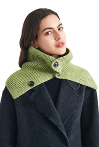 Close-up of light green knit neck warmer with three dark buttons and ribbed texture