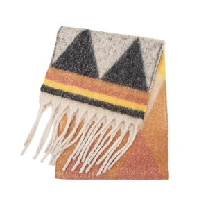 Detailed view of winter scarf featuring thick jacquard geometric patterns and long tassels