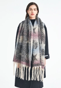 Close-up of winter thick knit scarf with star pattern, pastel gradients and long tassels