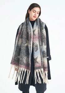 Detail showing the thick star pattern texture and long tassels on the winter scarf