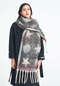 Detail of chunky knit scarf with star pattern and thick fringe in blue-grey gradient
