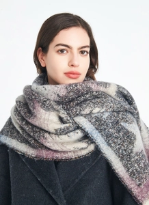 Detail of the thick purple and grey bouclé star pattern scarf with fringe edges