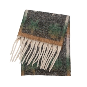 Detail of star jacquard pattern and chunky tassels on grey knit winter scarf