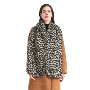 Thick winter leopard print scarf with whipstitch edges worn with a brown wool coat
