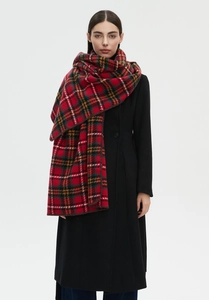 Detailed close-up of a warm red plaid scarf with high-quality locked edge craftsmanship